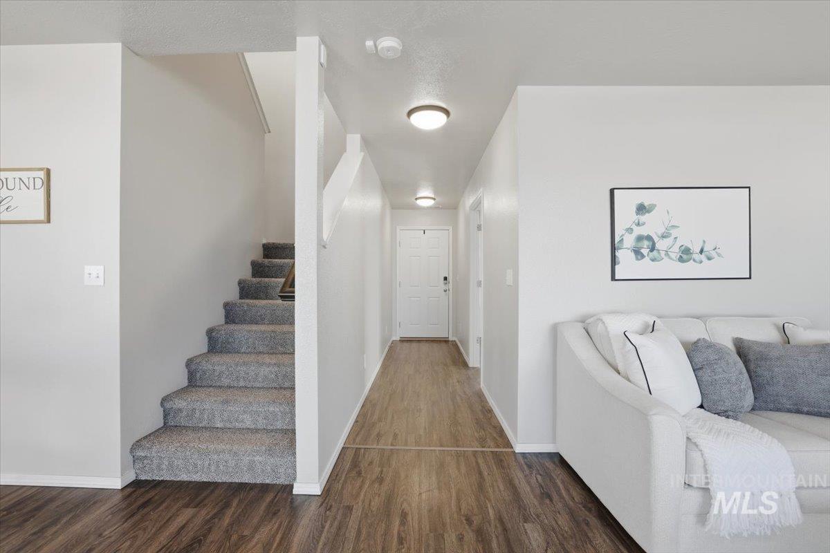 Hallway with stairs and dark wood finished floors
