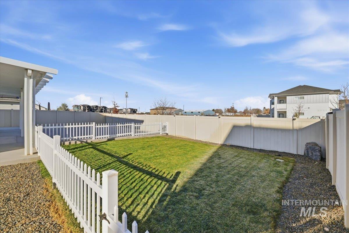 Fenced backyard with a residential view