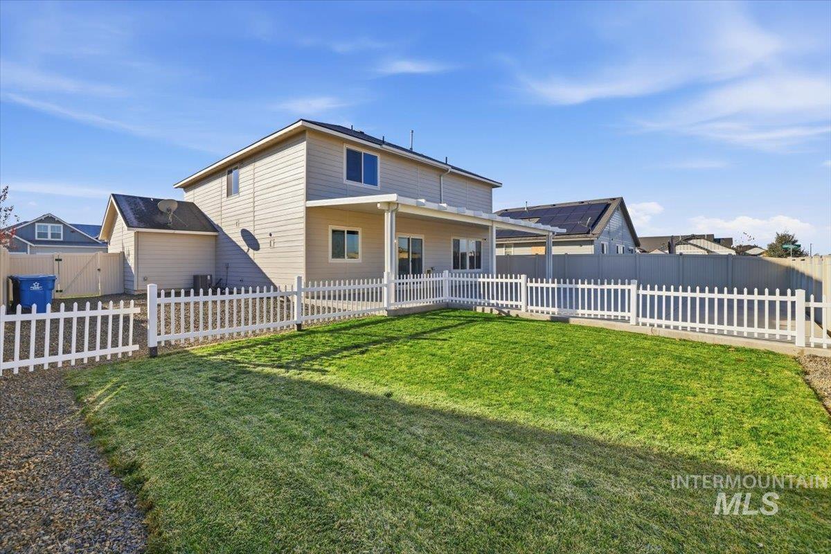 Rear view of property featuring a fenced backyard