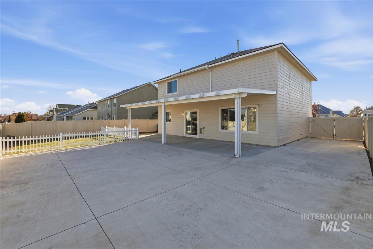 Back of house featuring a patio area and a gate