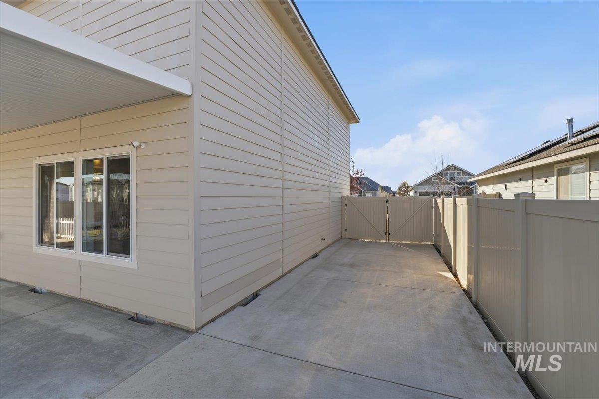 View of home's exterior with a patio area and a gate