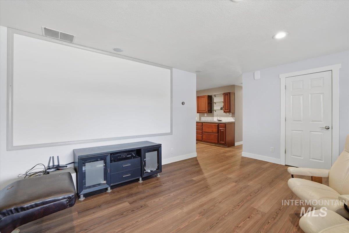 Cinema featuring wood finished floors and recessed lighting
