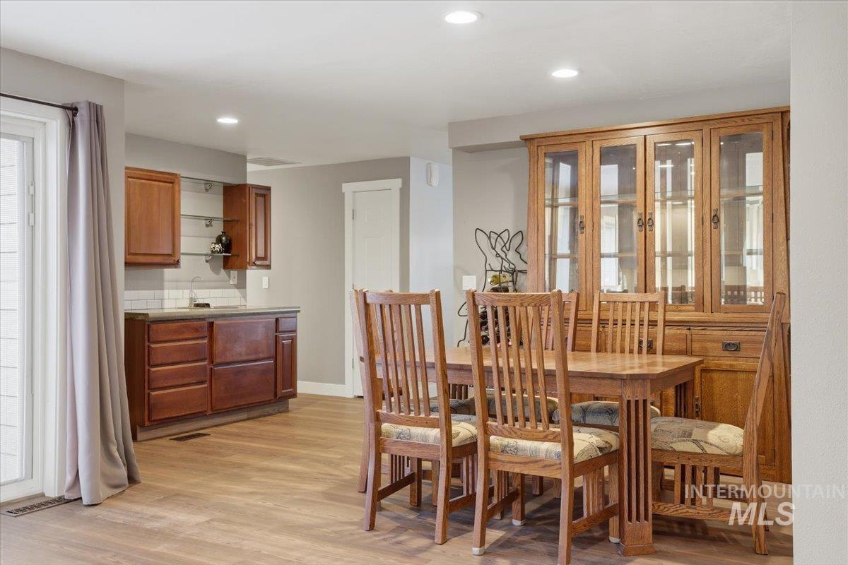 Dining room featuring light wood-style flooring and recessed lighting