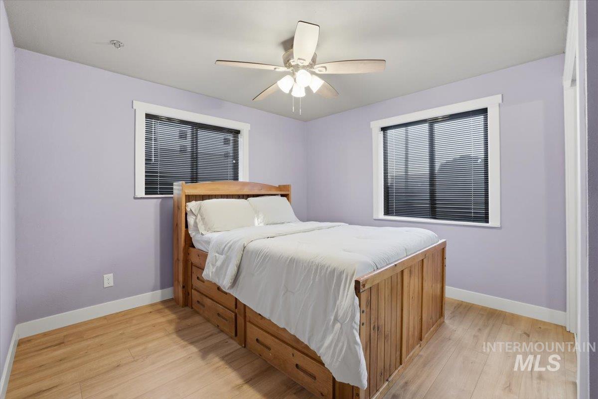 Bedroom with light wood-type flooring and ceiling fan