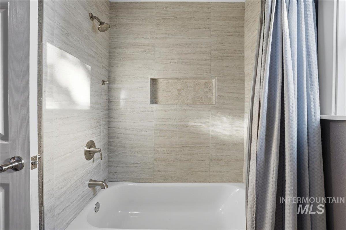 Bathroom with shower / tub combo with curtain