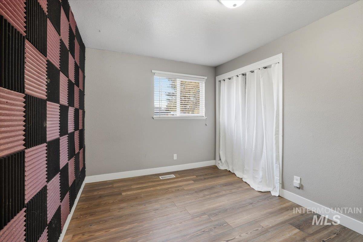 Unfurnished bedroom featuring wood finished floors and a textured ceiling