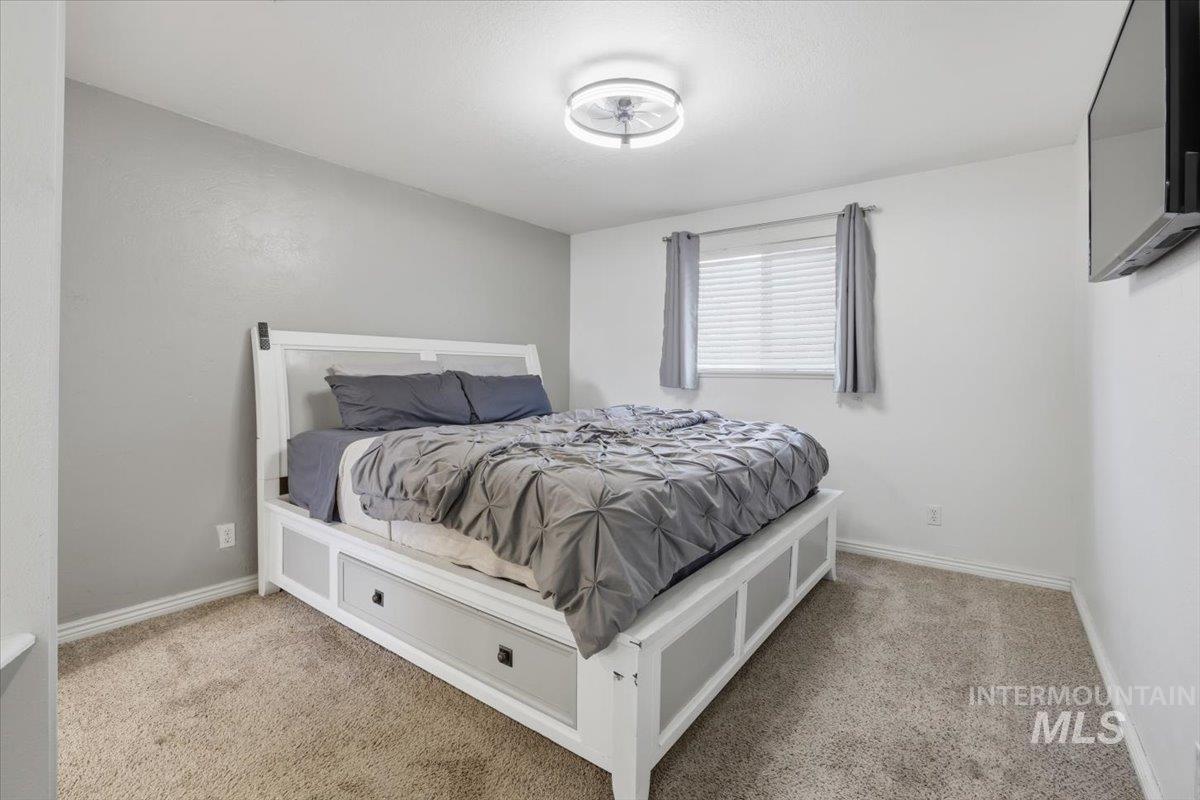 Bedroom with light colored carpet