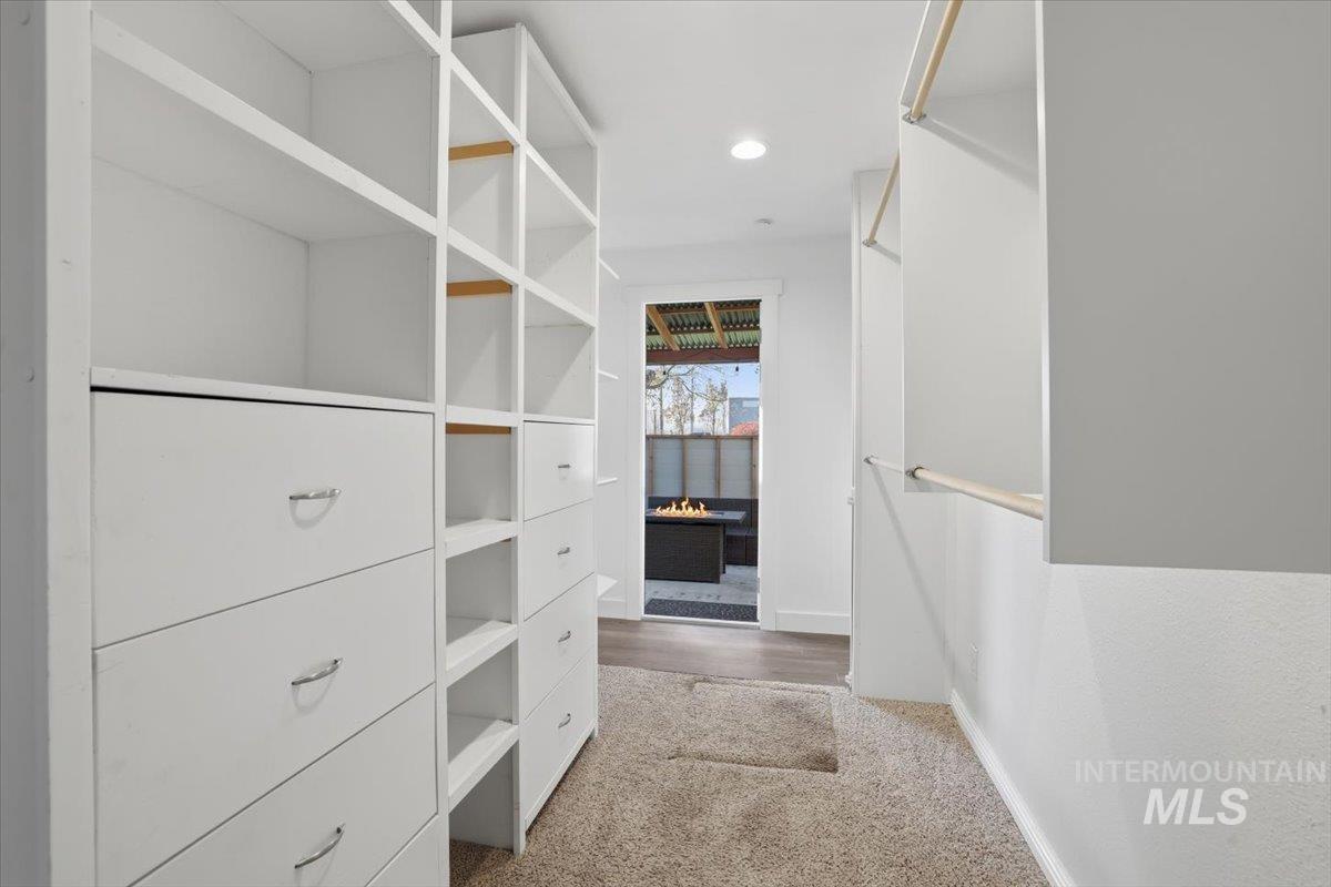 Spacious closet featuring light colored carpet