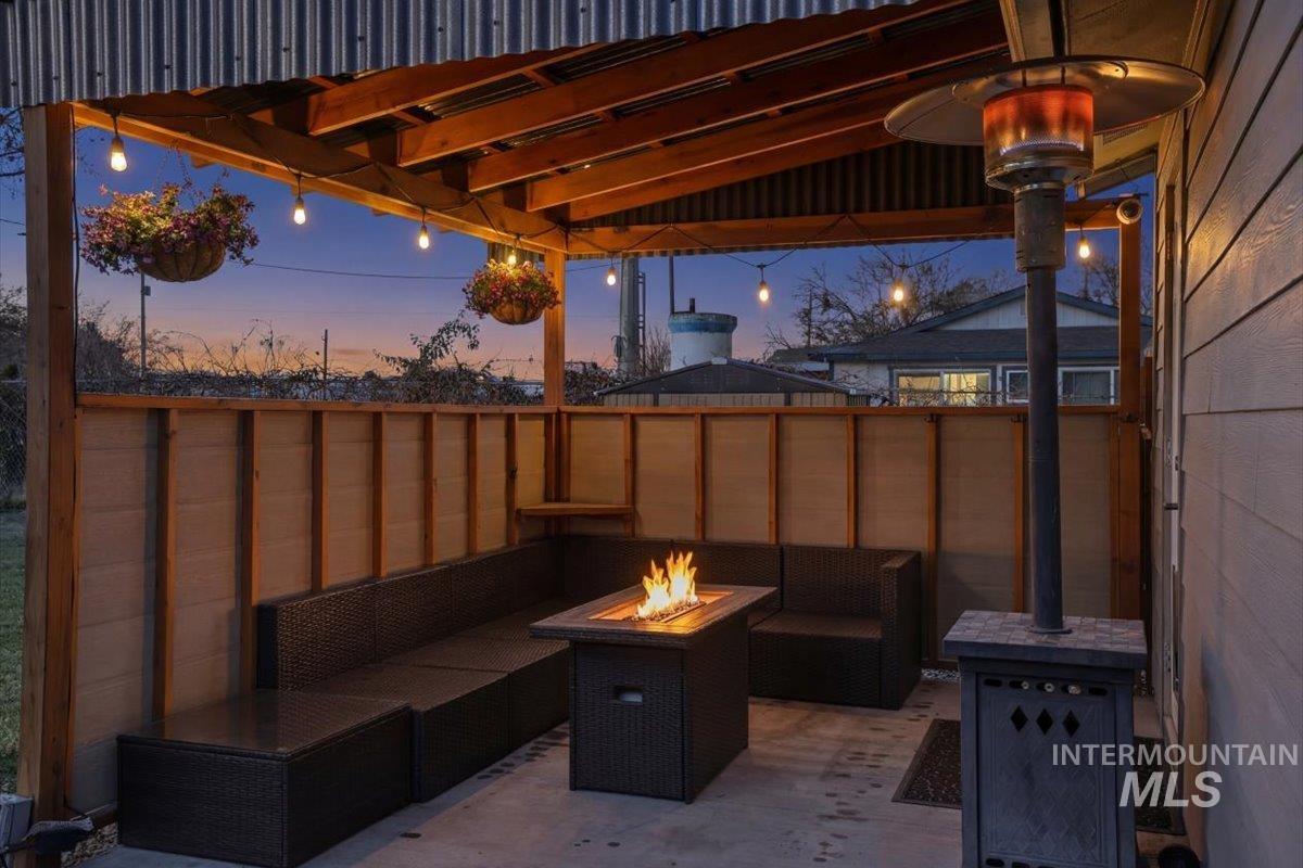 View of patio featuring an outdoor living space with a fire pit