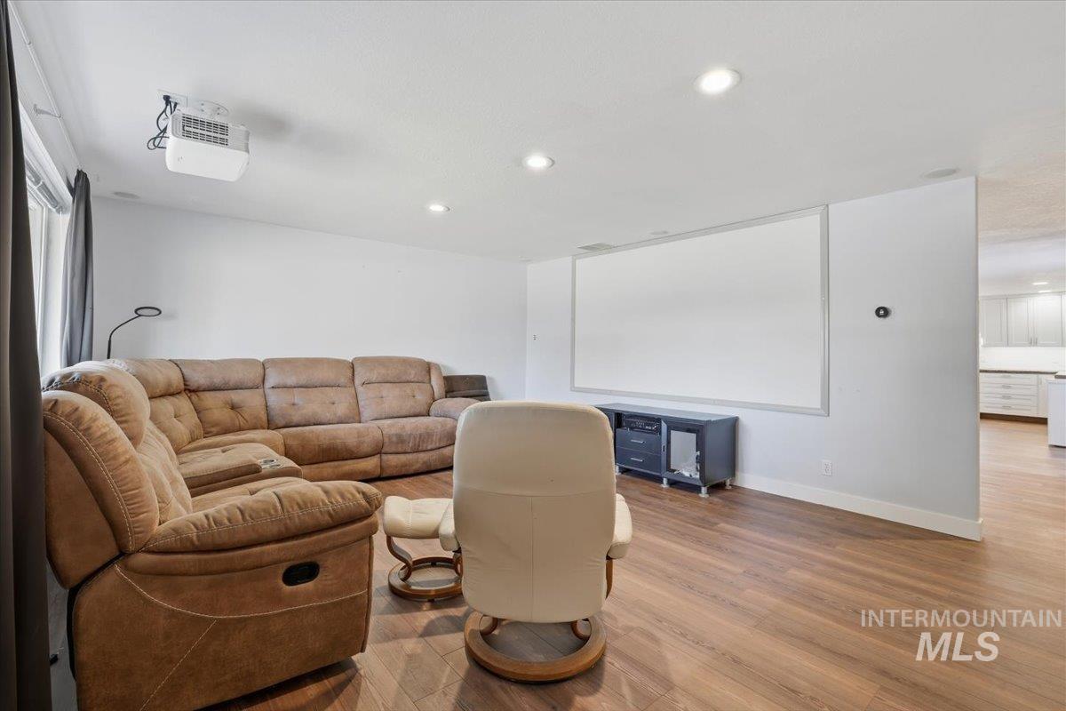 Living area featuring wood finished floors and recessed lighting