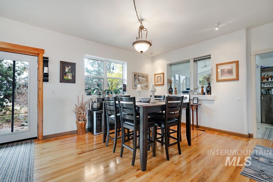 Dining space with light wood-style flooring and baseboards