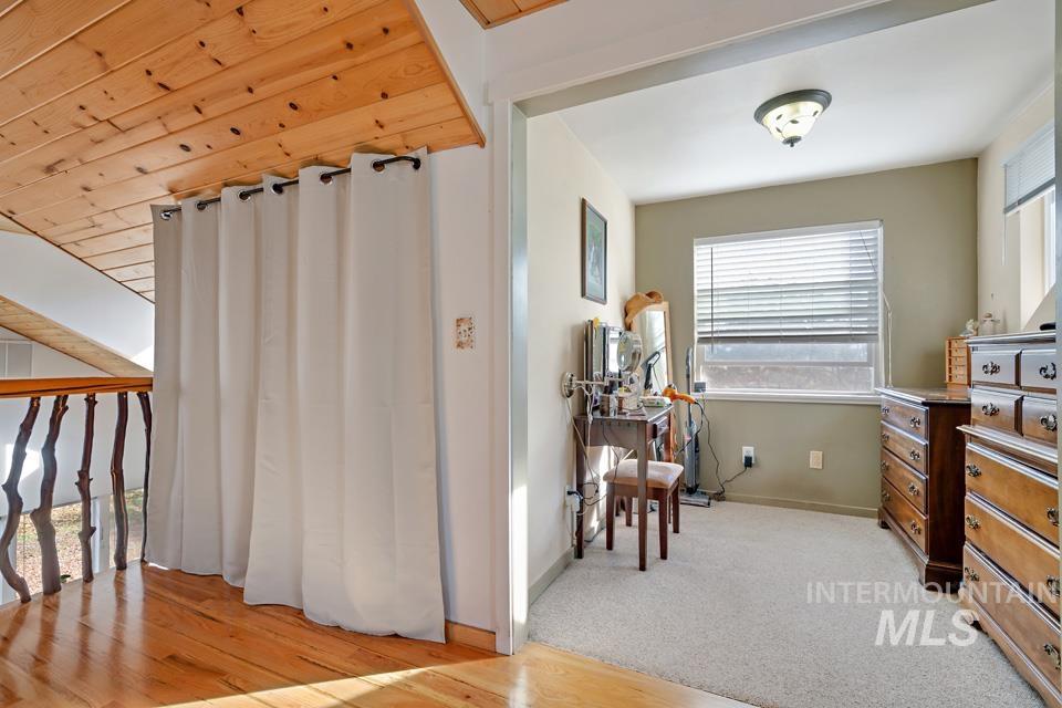 Living area featuring light carpet and light wood-style floors