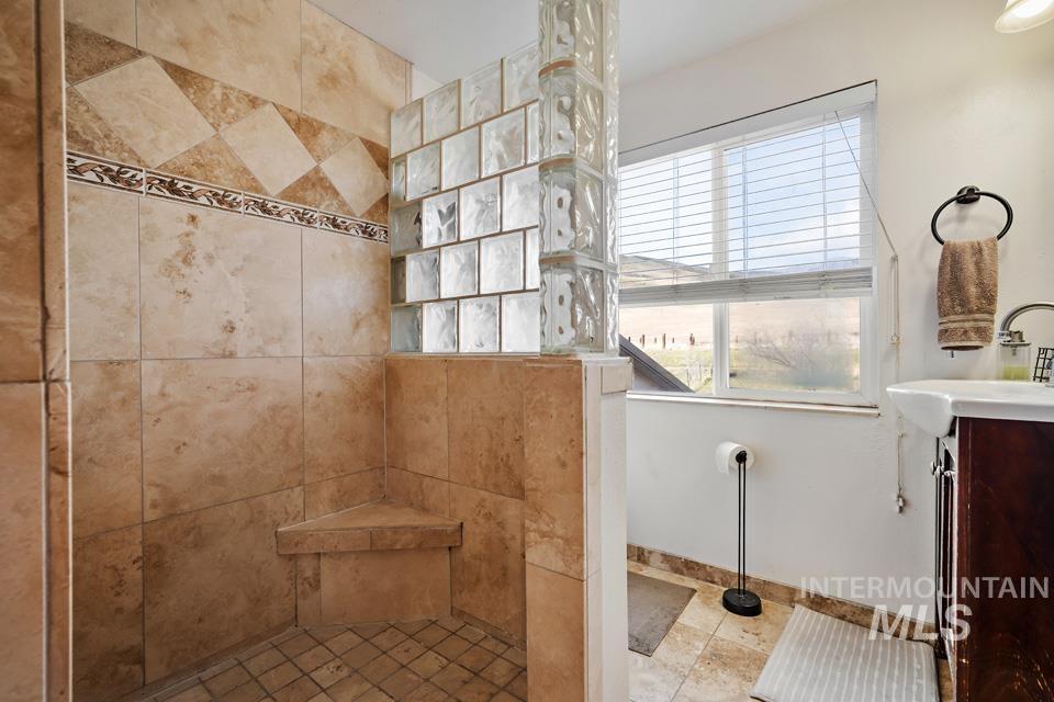 Bathroom featuring vanity and a walk in shower