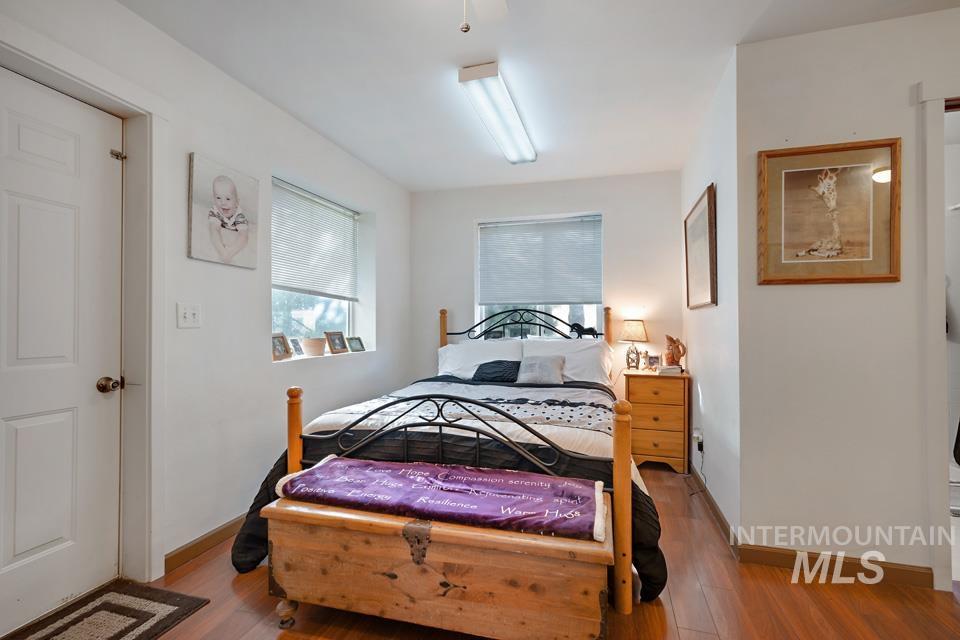 Bedroom with wood finished floors and baseboards