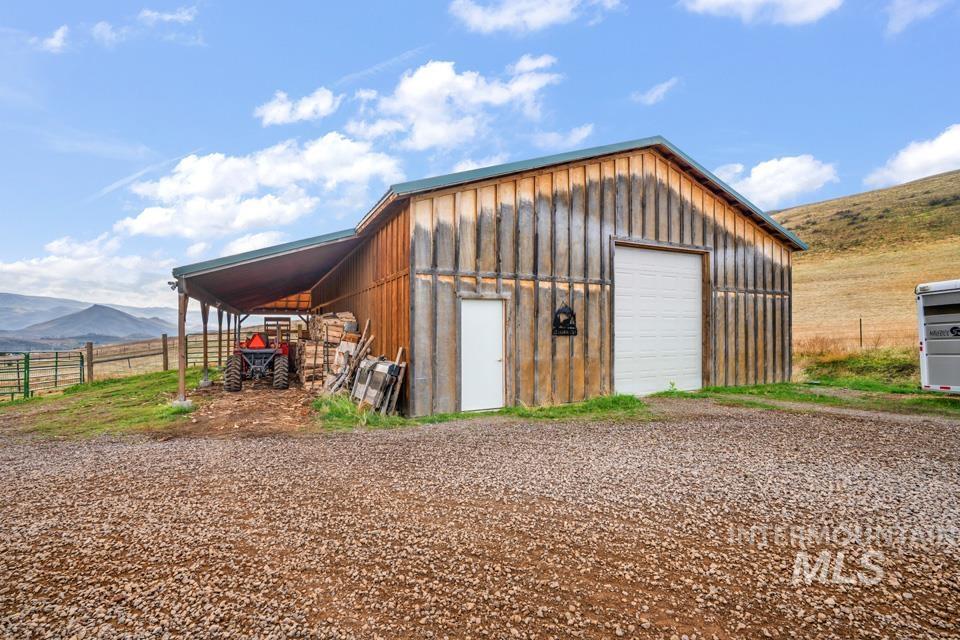Garage with a garage, a mountain view, and a rural view