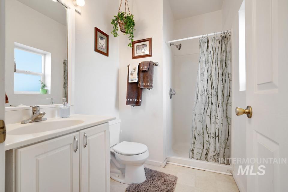 Full bathroom with vanity and a shower stall