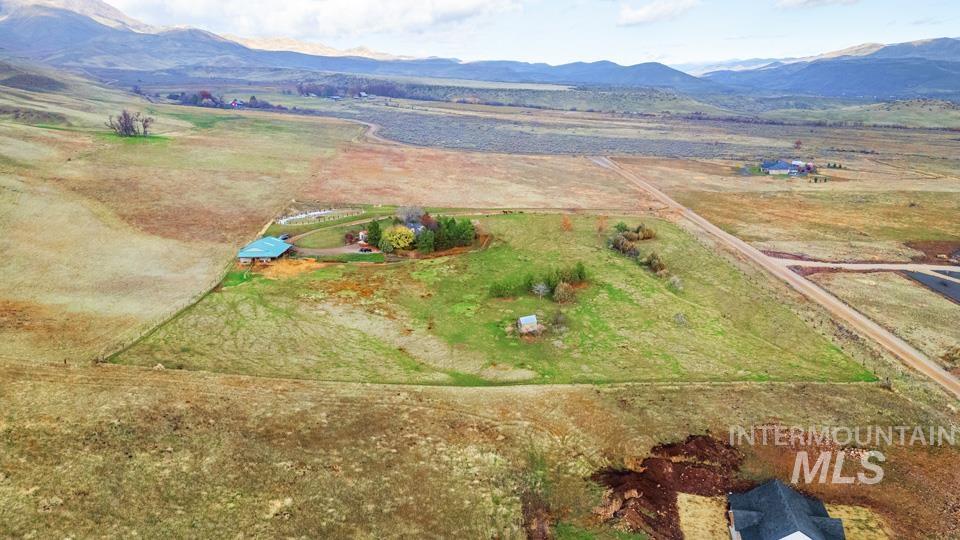 Aerial overview of property's location featuring rural landscape and mountains