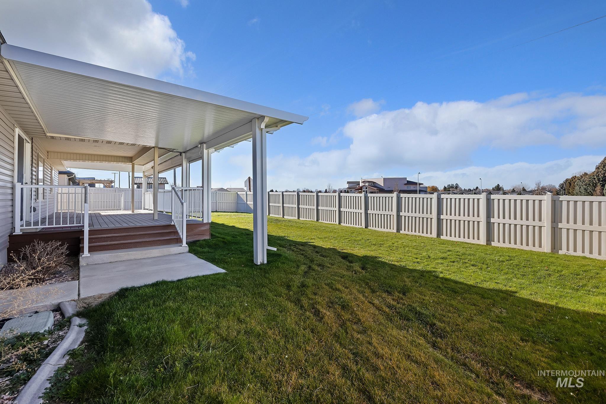 Fenced backyard with a deck and a patio area