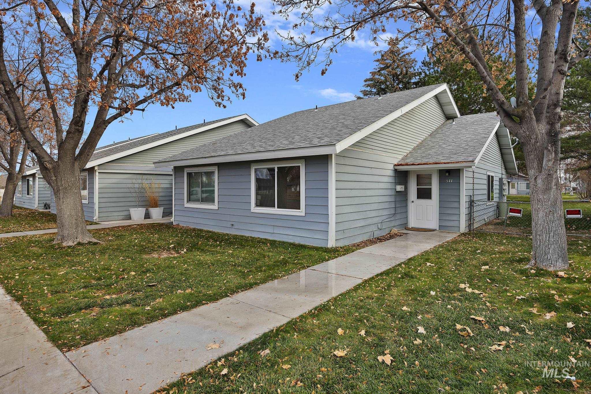 View of front of house featuring roof with shingles and a front lawn