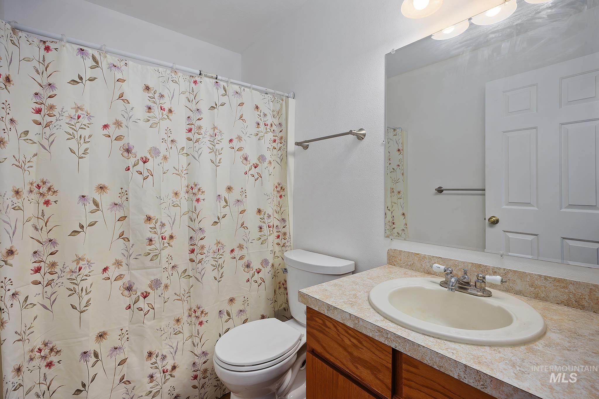 Full bathroom featuring vanity and a shower with shower curtain