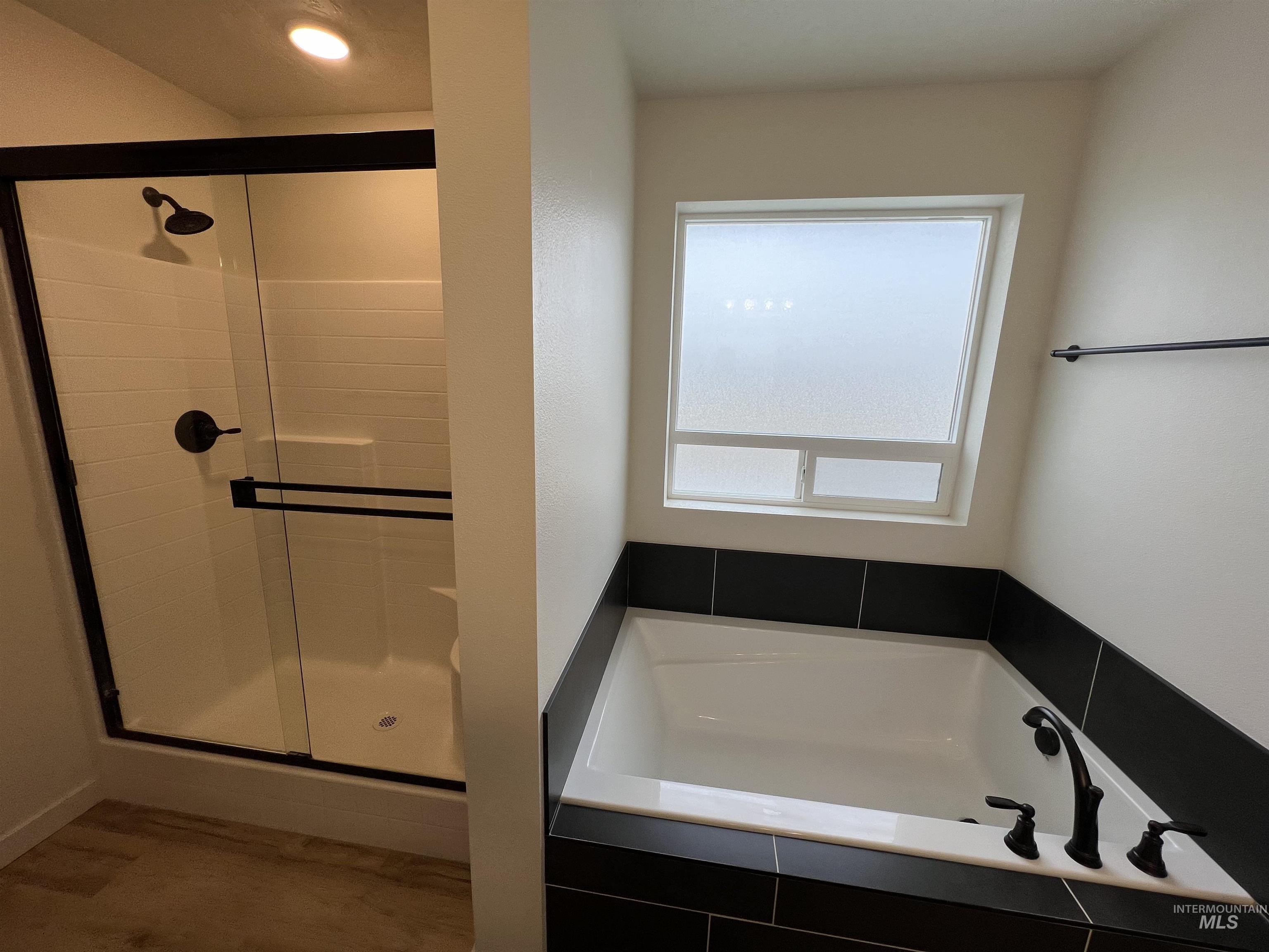 Bathroom with a garden tub and a stall shower