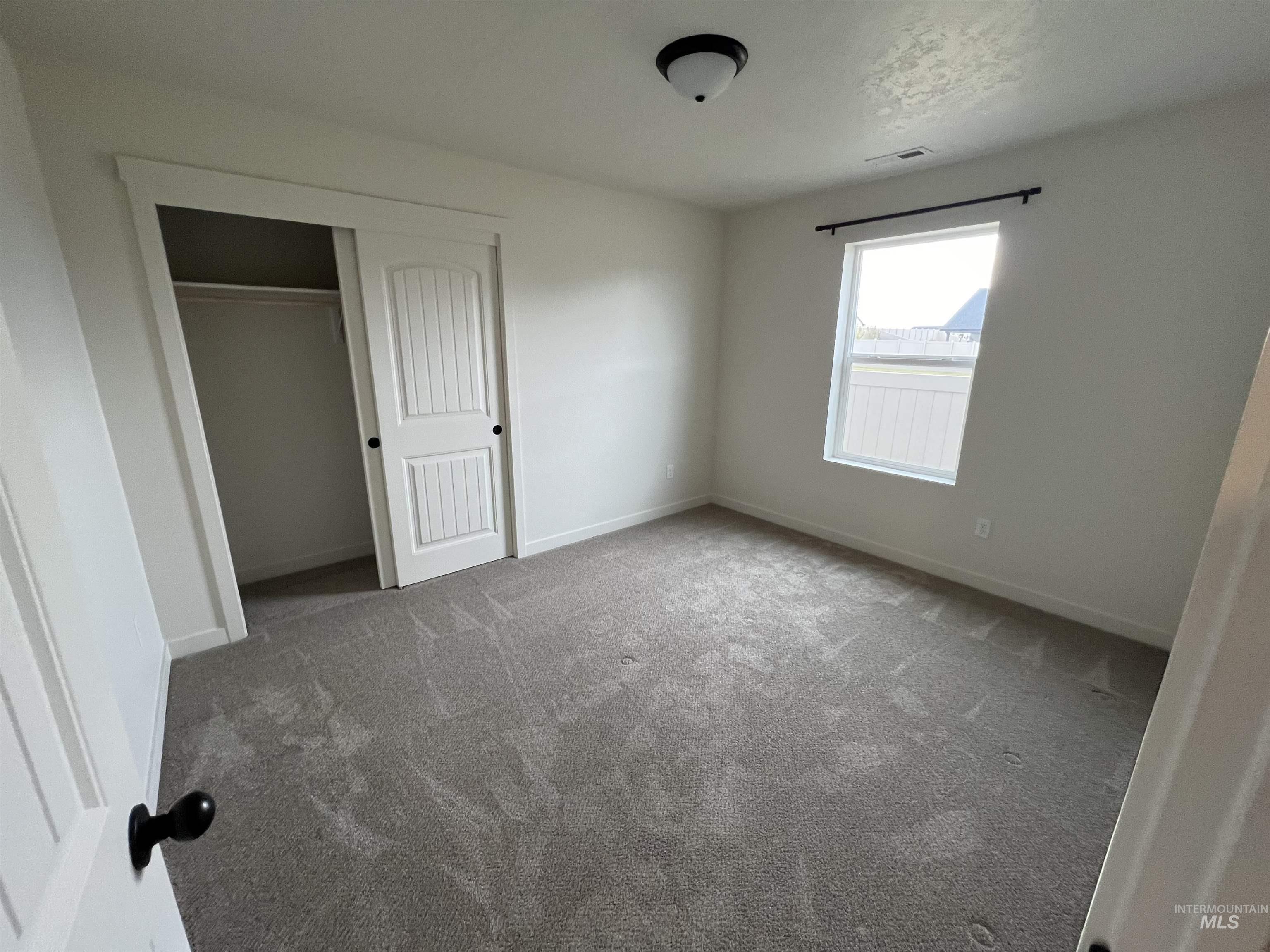 Unfurnished bedroom with a closet and carpet