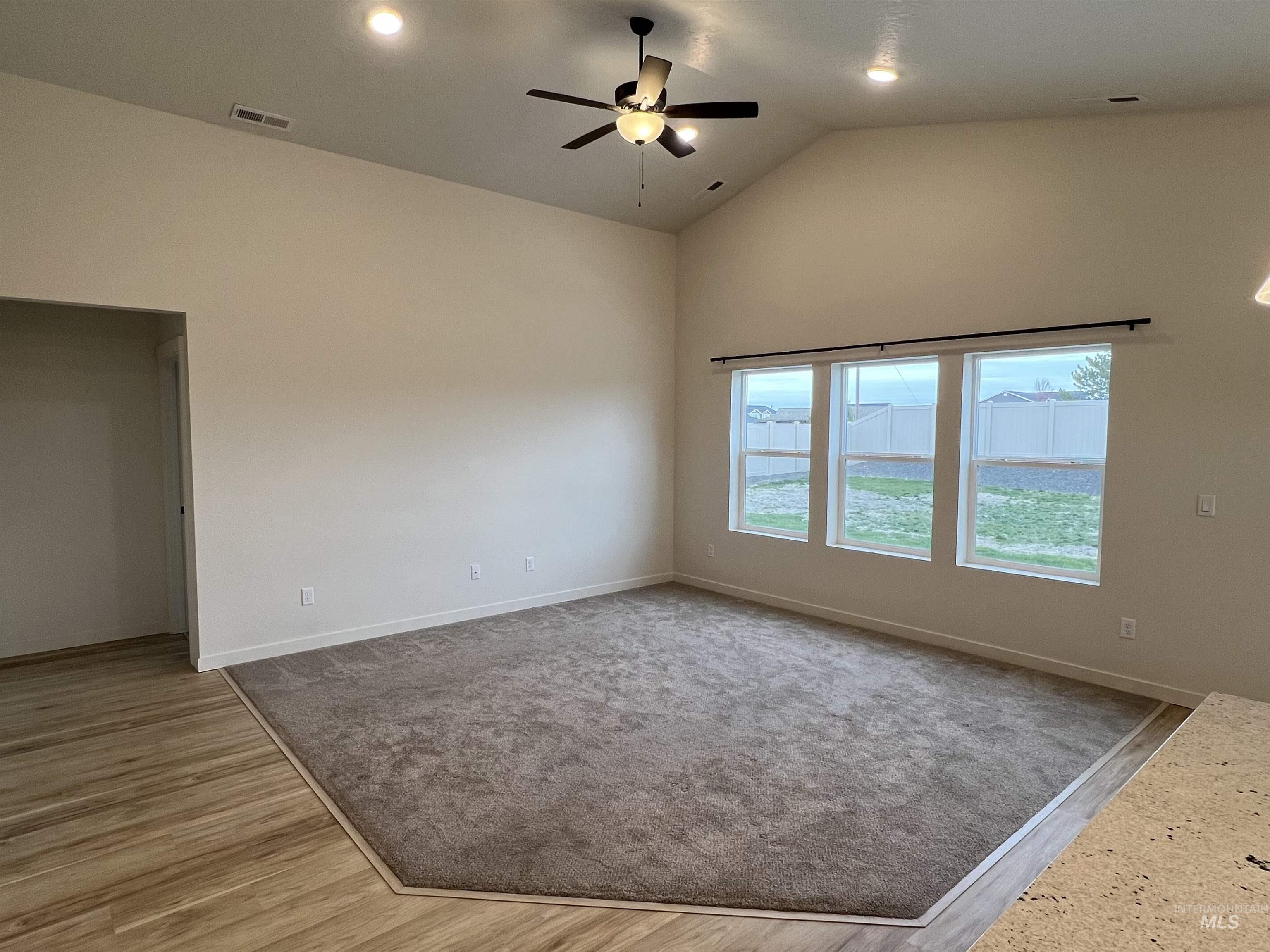 Unfurnished room with high vaulted ceiling, ceiling fan, recessed lighting, and light wood-type flooring