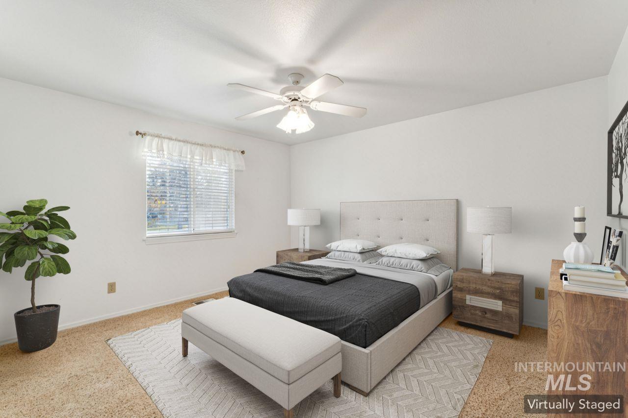 Bedroom with a ceiling fan and light carpet