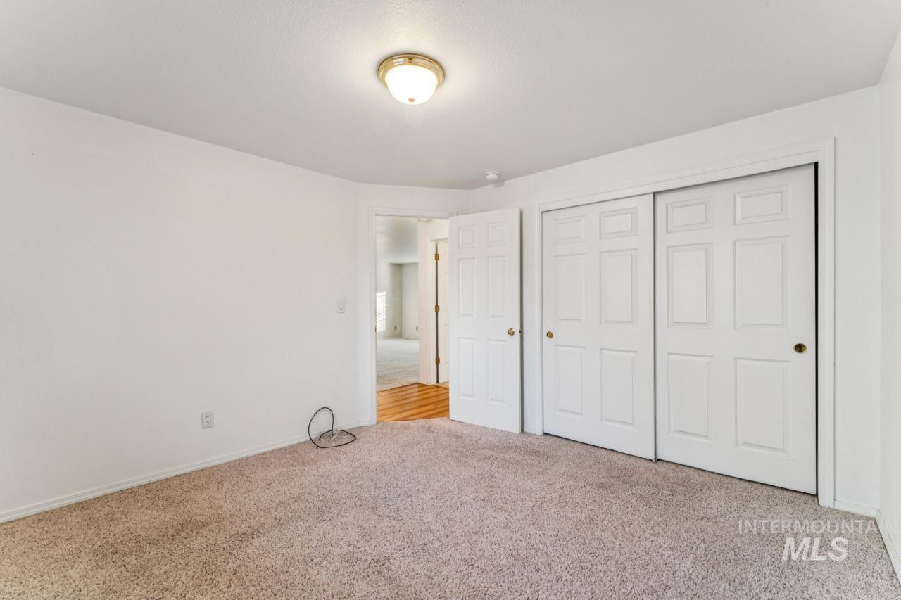 Unfurnished bedroom featuring light colored carpet and a closet
