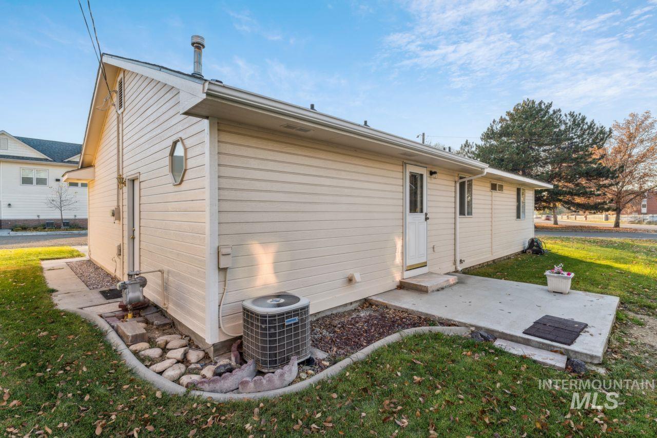 Back of property featuring a yard and a patio area