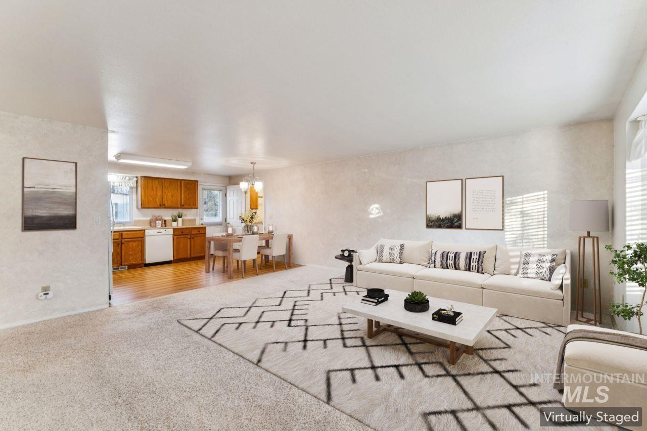 Living room with light carpet and a chandelier