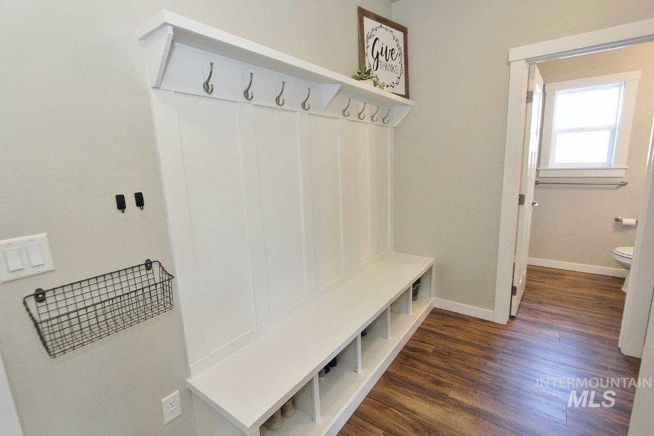 Mudroom with dark wood-style floors and baseboards