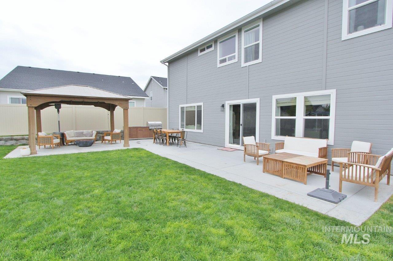 Rear view of property with an outdoor hangout area, a patio, and a gazebo