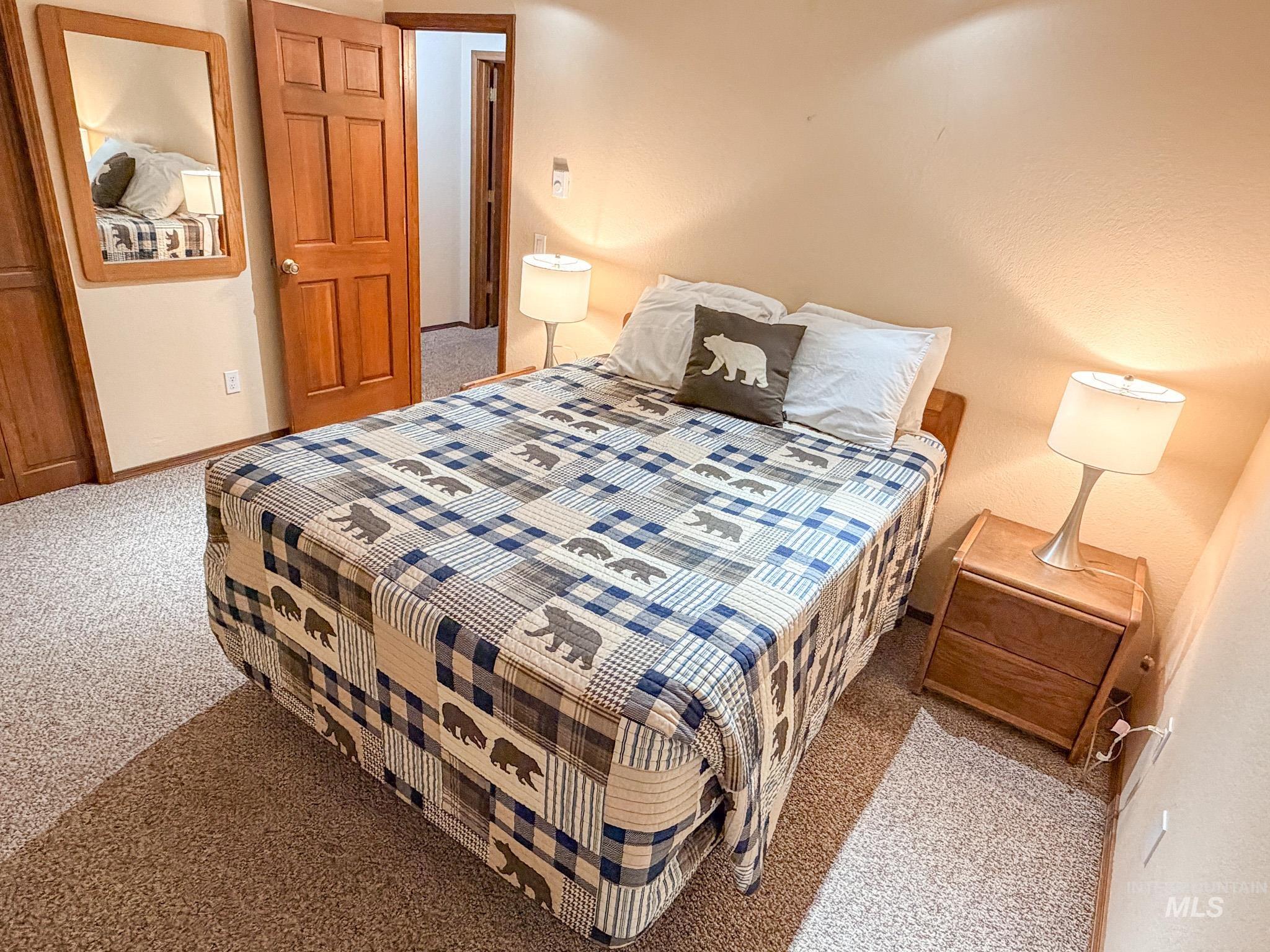 Bedroom with light carpet and baseboards