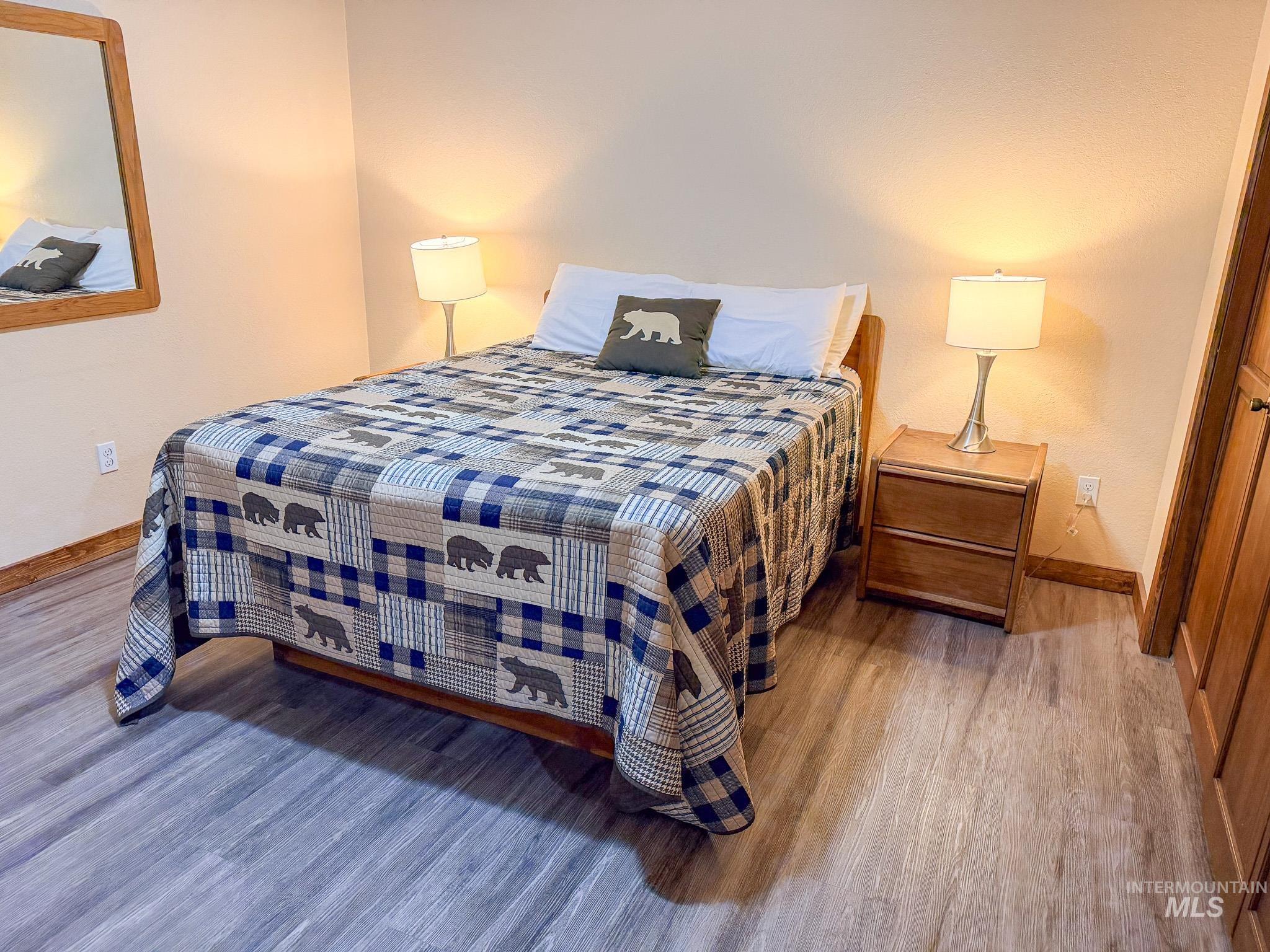 Bedroom with baseboards and wood finished floors