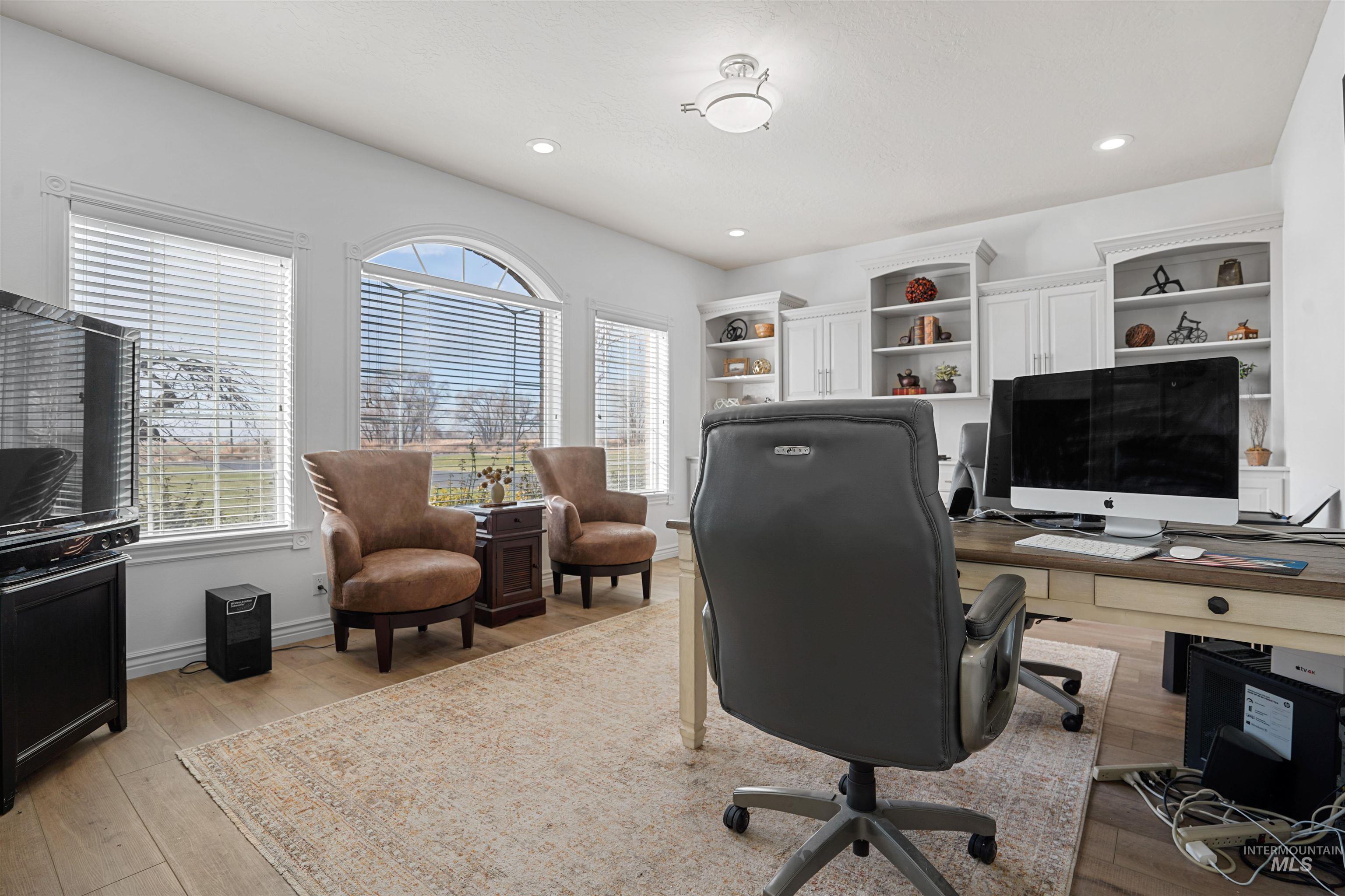 Office featuring light wood finished floors and recessed lighting
