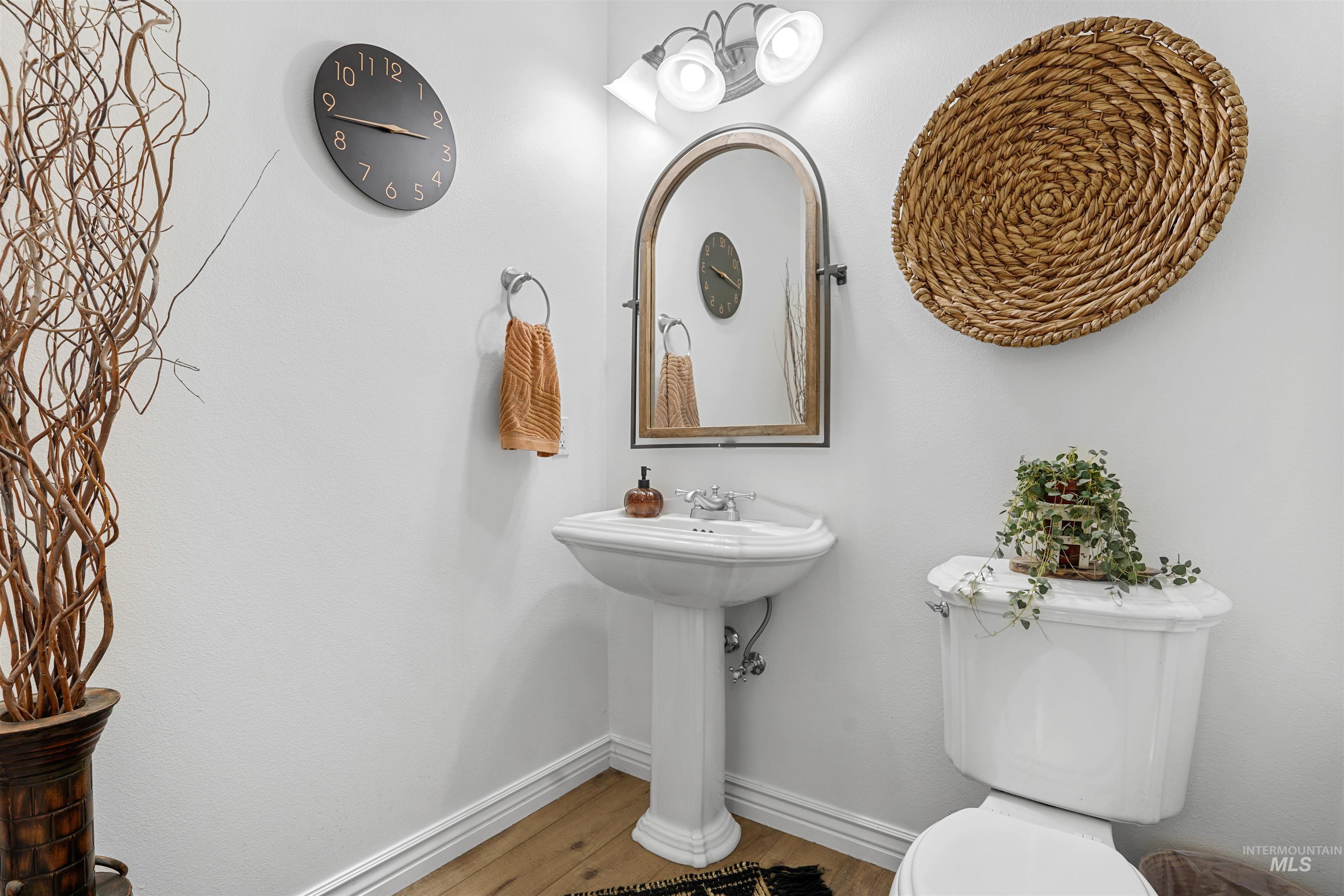 Bathroom featuring baseboards and wood finished floors