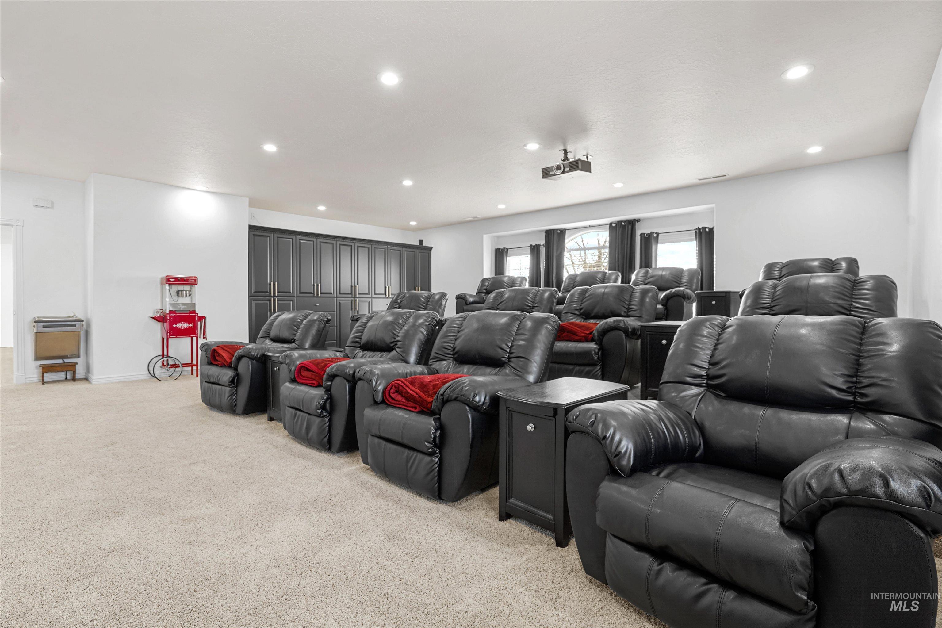 Home theater featuring light colored carpet and recessed lighting