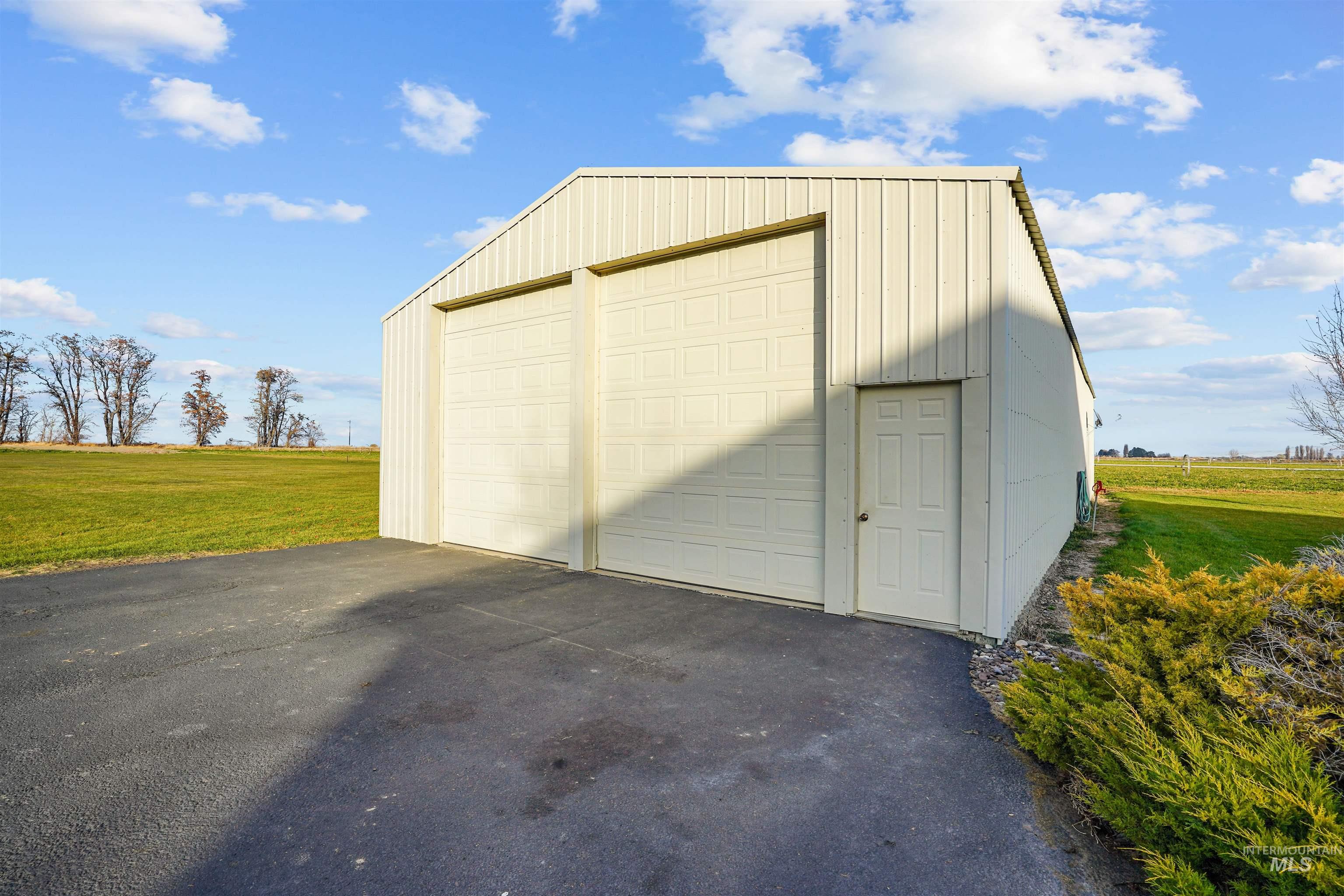 Detached garage with a view of rural / pastoral area