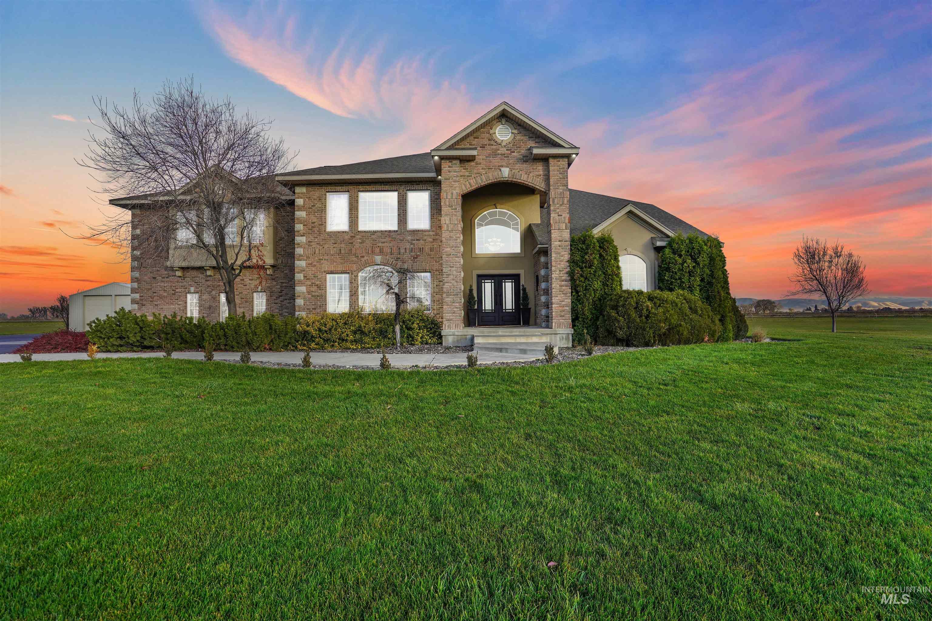 Traditional-style house with a lawn, stucco siding, and french doors