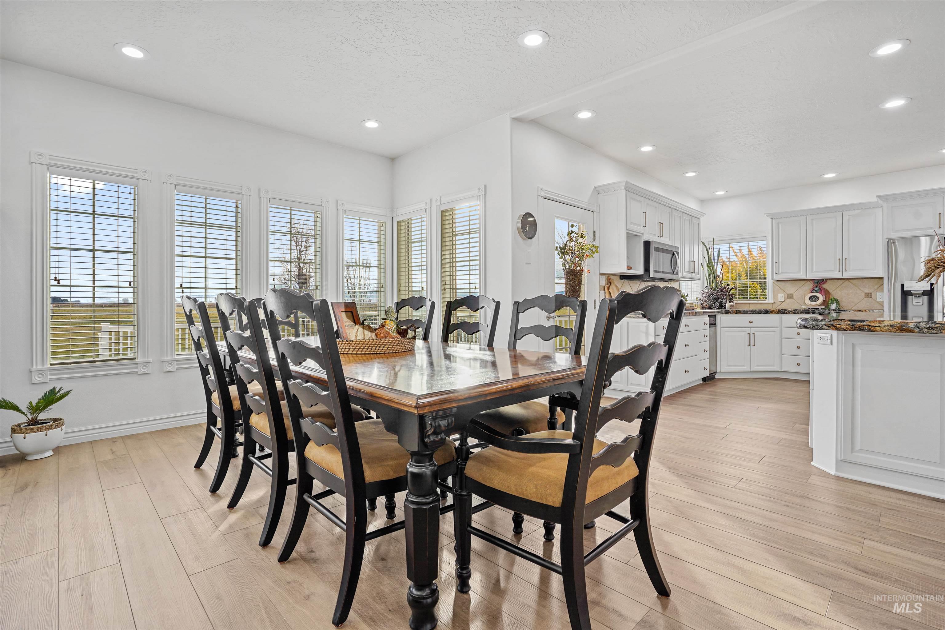 Dining space featuring light wood-type flooring and recessed lighting