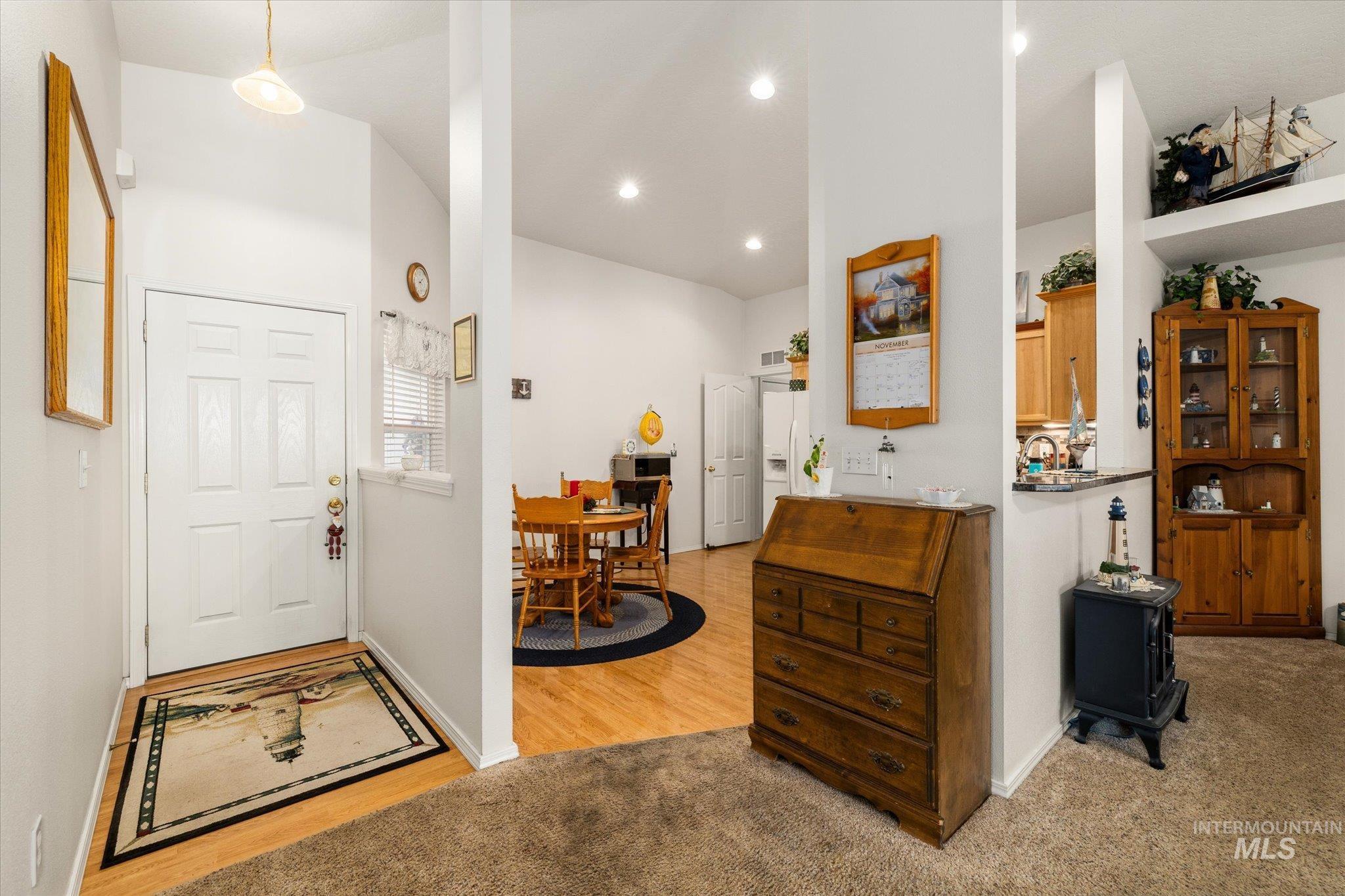 Entrance foyer featuring recessed lighting and light carpet