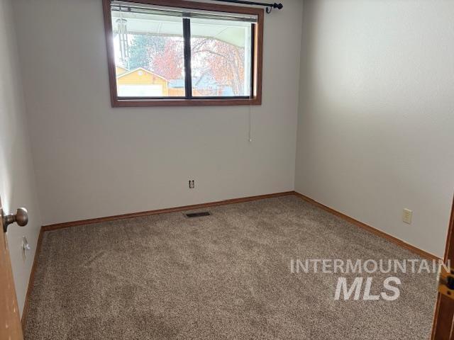 Unfurnished room featuring carpet flooring and healthy amount of natural light
