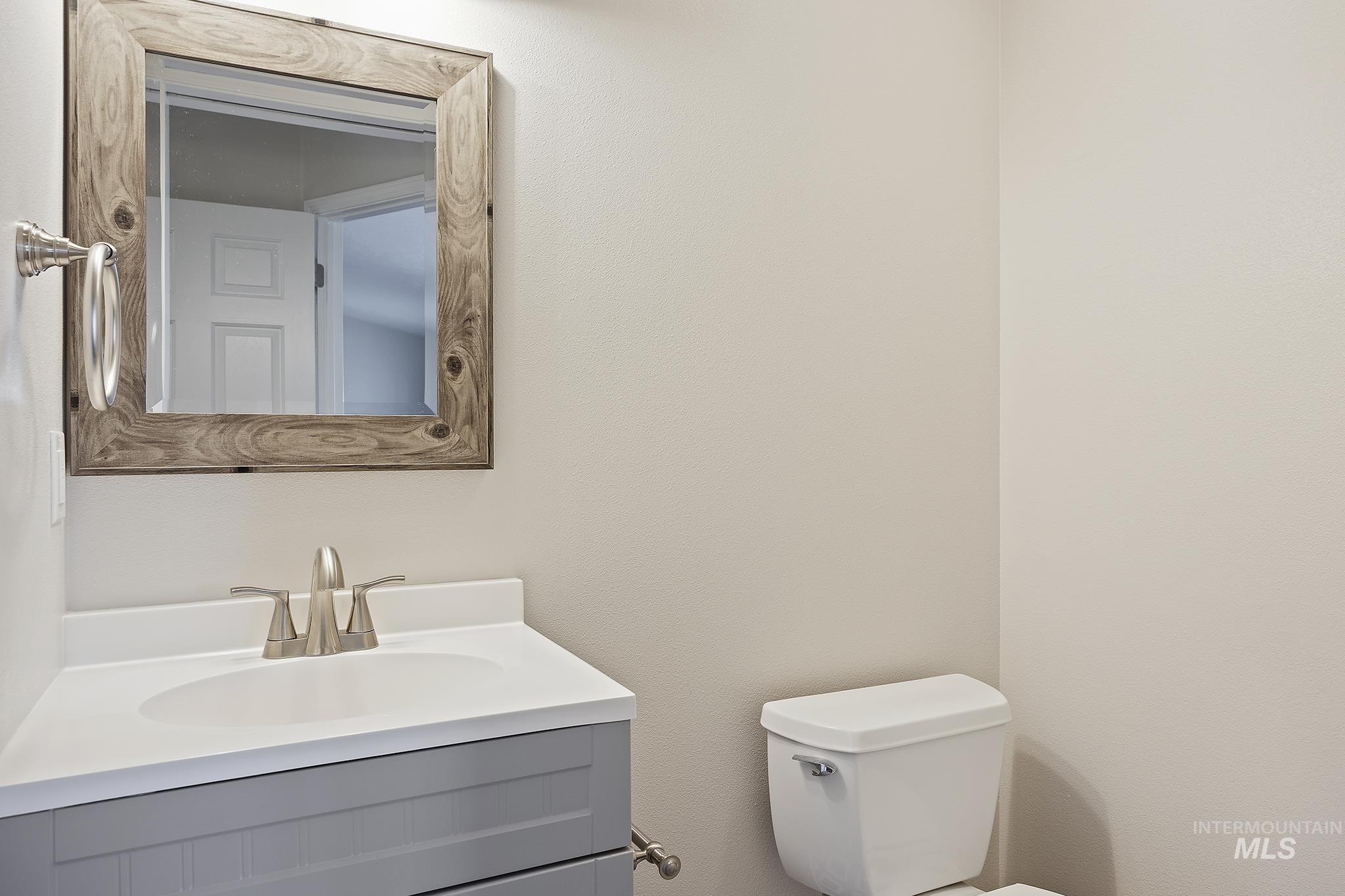 Half bath featuring vanity and toilet