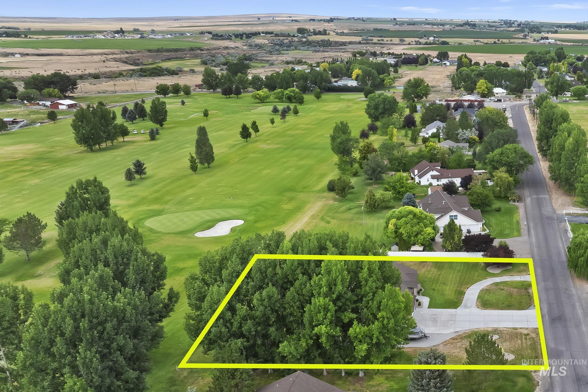 Aerial overview of property's location featuring a local golf course and property parcel outlined