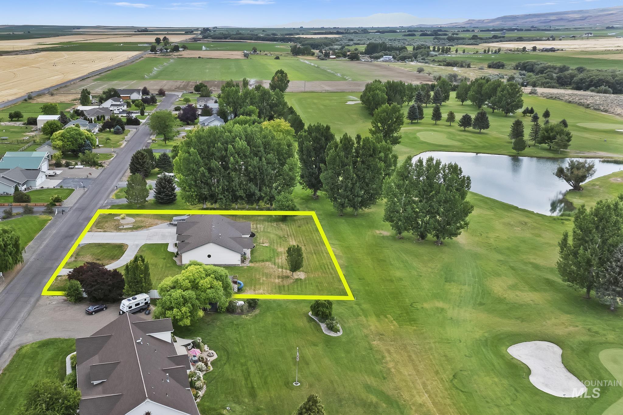 View of property location featuring a large body of water, property boundaries highlighted, and a golf club