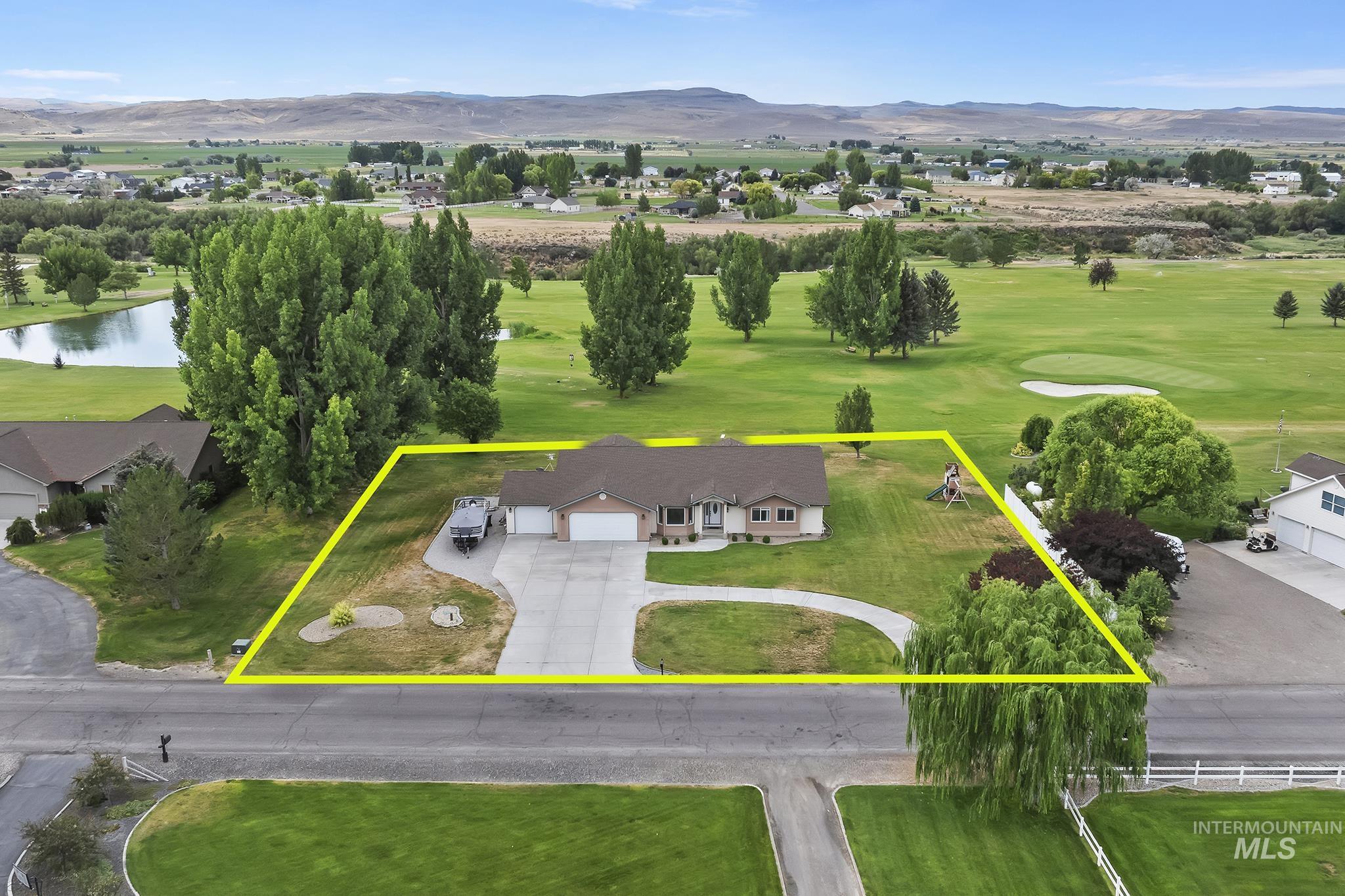Aerial overview of property's location featuring a water and mountain view, property boundaries highlighted, and a local golf course