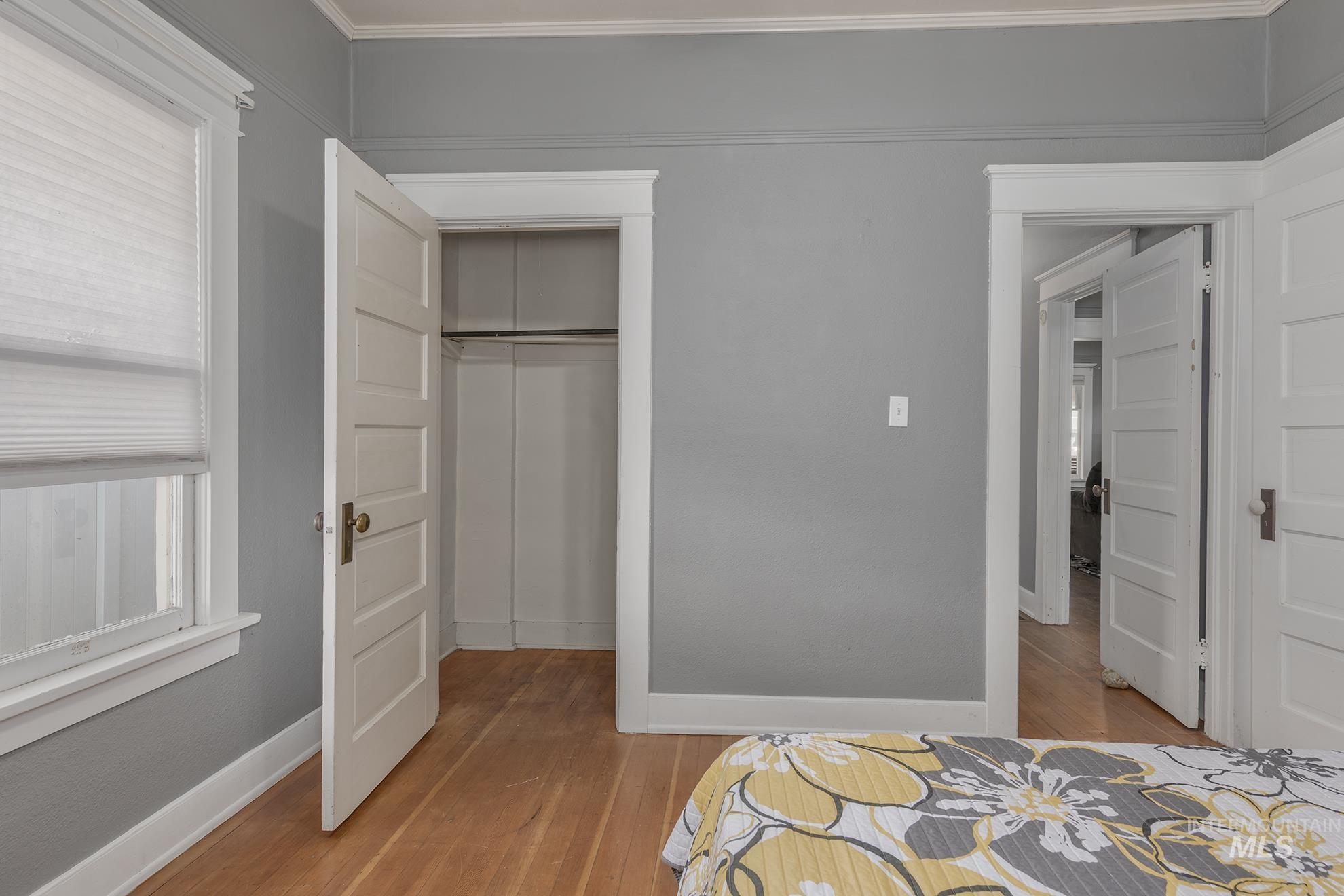 Unfurnished bedroom featuring light wood-type flooring and a closet