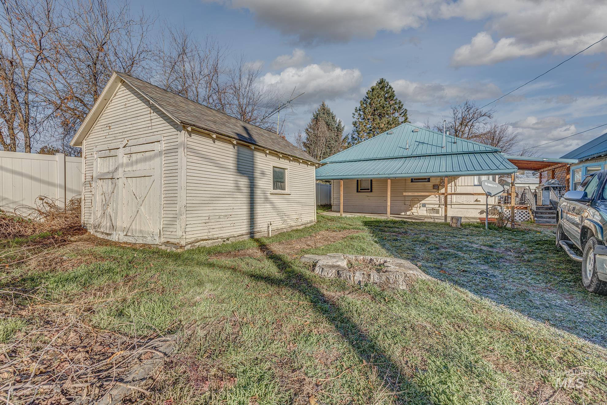 Rear view of property with a storage unit