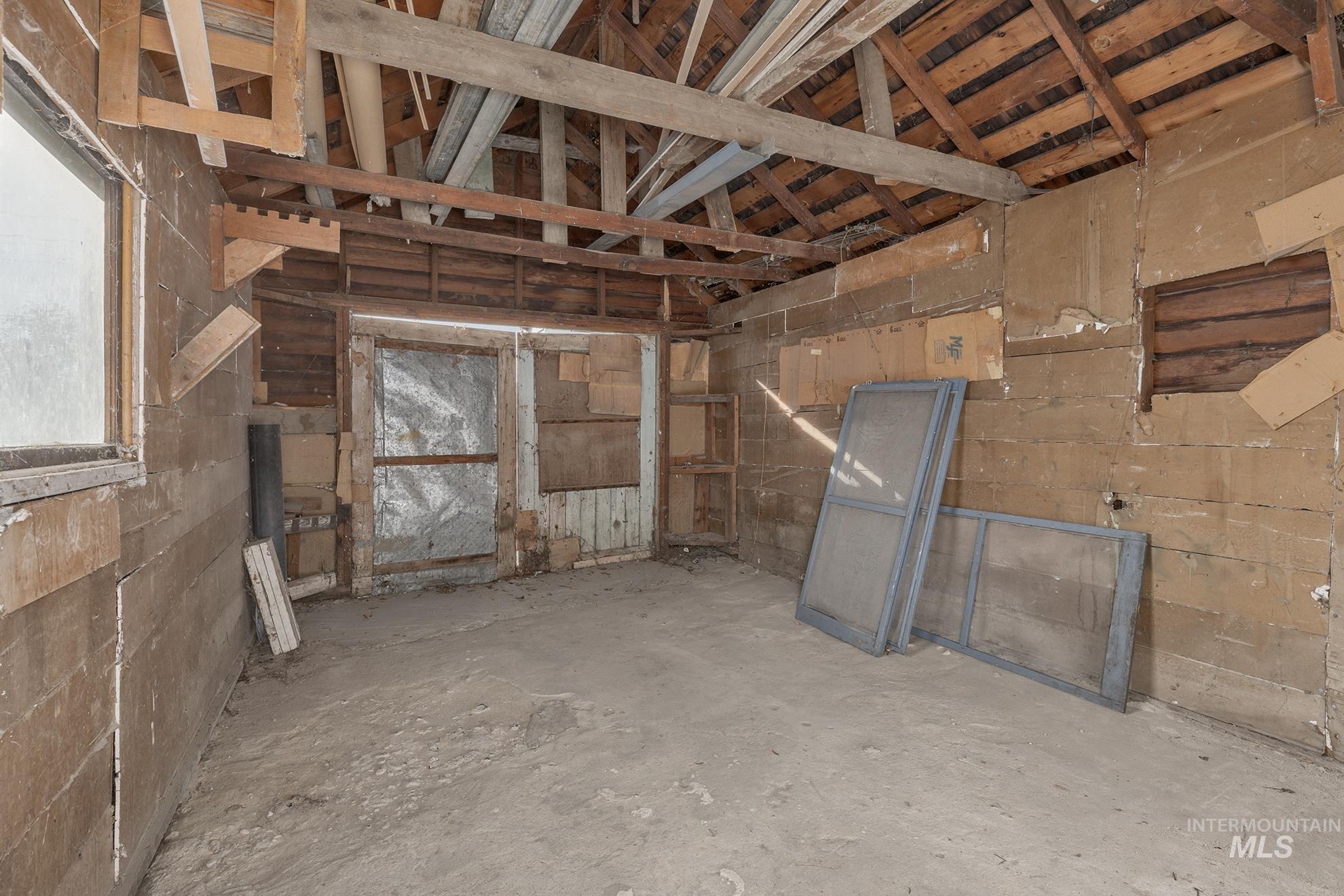 Misc room featuring unfinished concrete flooring